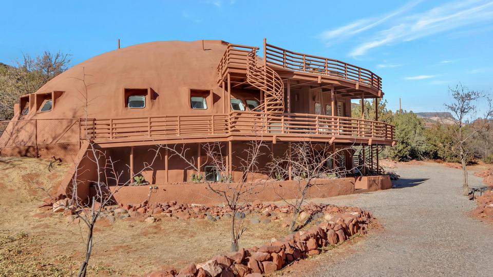 Huge red rock covered Monolithic Dome home in Sedona, Arizona.